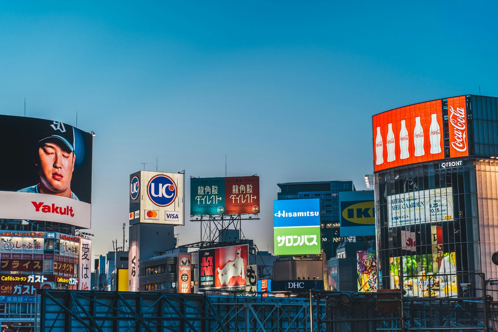 a city with lots of billboards and buildings